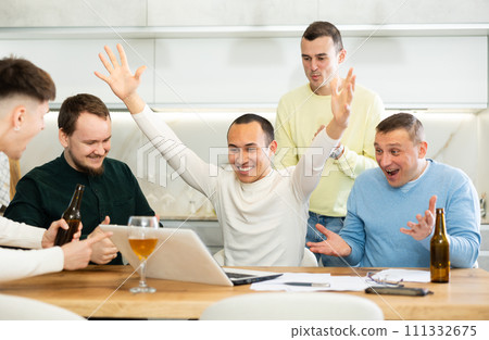 Happy male friends exulting after successful virtual investment Happy male friends exulting after successful virtual investment 111332675