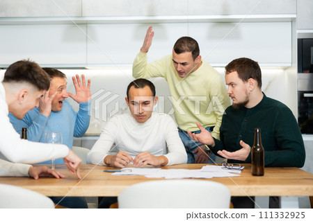 Group of men supporting troubled friend reading legal notice 111332925