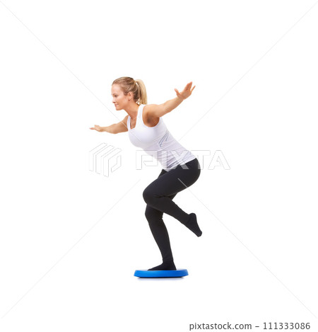 Balance, exercise and fitness with woman on disk in studio for workout, mindfulness or health. Wellness, challenge and training with person on white background for flexibility, smile or aerobics 111333086