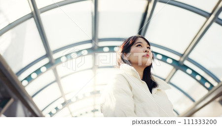 Thinking, city and Japanese woman on bridge on commute, travel and journey in metro. Student, fashion and person with trendy clothes, backpack or bag for university, college and adventure in town 111333200