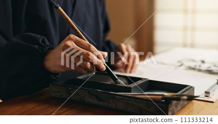 Hands, brush in ink for writing and Japanese calligraphy or ancient script for art and inkstone. Asian creativity, black paint and vintage tools, paintbrush and person with traditional stationery Hands, brush in ink for writing and Japanese calligraphy or ancient script for art and inkstone. Asian creativity, black paint and vintage tools, paintbrush and person with traditional stationery 111333214