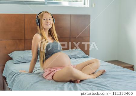 Expectant mom finds joy in her pregnancy, listening to soothing music for a serene and harmonious connection with her unborn baby Expectant mom finds joy in her pregnancy, listening to soothing music for a serene and harmonious connection with her unborn baby 111333400