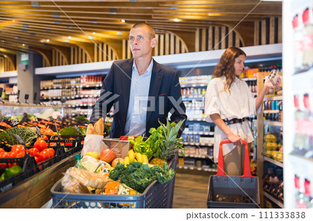Portrait of a confident young couple in the supermarket 111333838