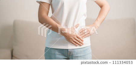 Woman having abdomen pain on the sofa at home. Liver cancer and Tumor, kidney cancer, Jaundice, Viral Hepatitis, Cirrhosis, Failure, Enlarged, Hepatic Encephalopathy, Stomach and health concept Woman having abdomen pain on the sofa at home. Liver cancer and Tumor, kidney cancer, Jaundice, Viral Hepatitis, Cirrhosis, Failure, Enlarged, Hepatic Encephalopathy, Stomach and health concept 111334053