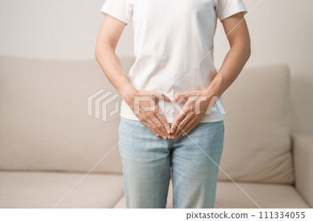 Woman hand heart shape over abdomen. Ovarian and Cervical cancer, Endometriosis, Hysterectomy, Uterine fibroids, Reproductive, menstruation, Stomach, Pregnancy and Sexual Transmitted disease concept 111334055