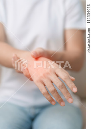 Woman having wrist pain during sitting on sofa at home, muscle ache due to De Quervain s tenosynovitis, ergonomic, Carpal Tunnel Syndrome or Office syndrome concept Woman having wrist pain during sitting on sofa at home, muscle ache due to De Quervain s tenosynovitis, ergonomic, Carpal Tunnel Syndrome or Office syndrome concept 111334058