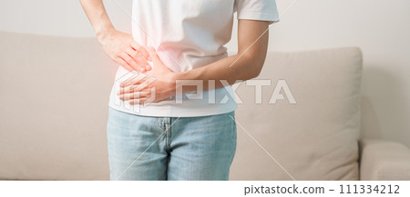 Woman having abdomen pain on the sofa at home. Liver cancer and Tumor, kidney cancer, Jaundice, Viral Hepatitis, Cirrhosis, Failure, Enlarged, Hepatic Encephalopathy, Stomach and health concept 111334212