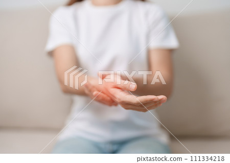 Woman having wrist pain during sitting on sofa at home, muscle ache due to De Quervain s tenosynovitis, ergonomic, Carpal Tunnel Syndrome or Office syndrome concept Woman having wrist pain during sitting on sofa at home, muscle ache due to De Quervain s tenosynovitis, ergonomic, Carpal Tunnel Syndrome or Office syndrome concept 111334218