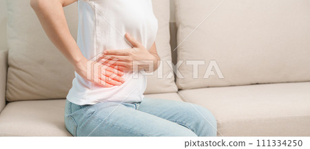 Woman having abdomen pain on the sofa at home. Liver cancer and Tumor, kidney cancer, Jaundice, Viral Hepatitis, Cirrhosis, Failure, Enlarged, Hepatic Encephalopathy, Stomach and health concept Woman having abdomen pain on the sofa at home. Liver cancer and Tumor, kidney cancer, Jaundice, Viral Hepatitis, Cirrhosis, Failure, Enlarged, Hepatic Encephalopathy, Stomach and health concept 111334250