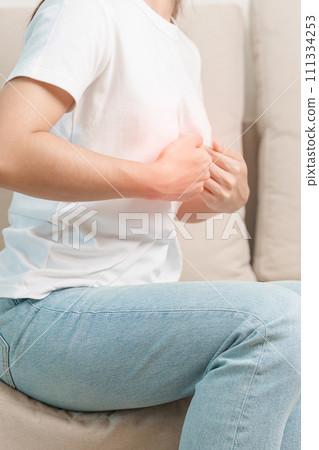 woman having abdomen ache due to Stomach pain, digestion with constipation or Diarrhea from food poisoning and liver cancer on the sofa at home woman having abdomen ache due to Stomach pain, digestion with constipation or Diarrhea from food poisoning and liver cancer on the sofa at home 111334253