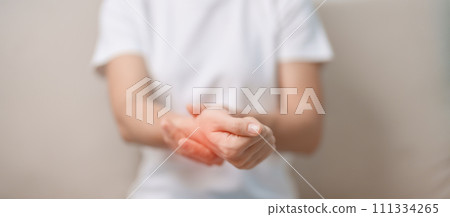 Woman having wrist pain during sitting on sofa at home, muscle ache due to De Quervain s tenosynovitis, ergonomic, Carpal Tunnel Syndrome or Office syndrome concept 111334265