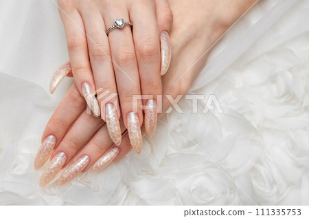 Hand of a young woman with white pearl  manicure 111335753