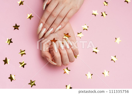 Hands with pearl manicure 111335756