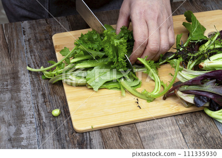 Muskran salad, vegetables, vegan salad, cut with a knife Muskran salad, vegetables, vegan salad, cut with a knife 111335930