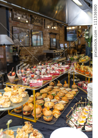 Catering banquet table with delicious food and snacks for party or corporate event 111336900