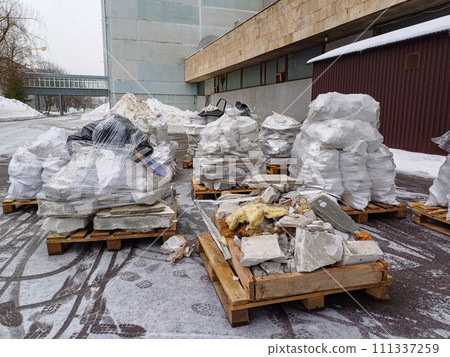 Construction waste lies on wooden pallets outdoors 111337259