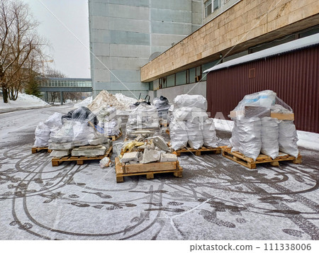 Several wooden pallets with construction waste  111338006
