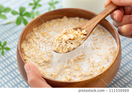 Hand of a woman eating oatmeal 111338989
