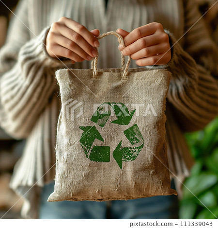 Sustainable living showcased in SHOTLISTeco Reusable bag displayed with pride, representing a shift towards eco-friendly alternatives. Sustainable living showcased in SHOTLISTeco Reusable bag displayed with pride, representing a shift towards eco-friendly alternatives. 111339043