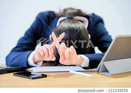 A woman in a suit who can't hide her tired appearance A woman in a suit who can't hide her tired appearance 111339550