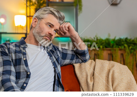 Disappointed middle-aged man after quarrel break-up or divorce problem feeling bad annoyed ill sick 111339629