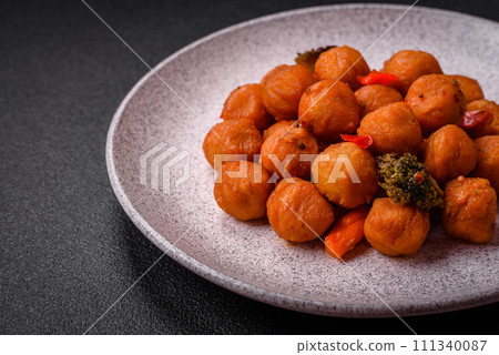 Delicious fried potato balls with vegetables, salt, spices and herbs Delicious fried potato balls with vegetables, salt, spices and herbs 111340087