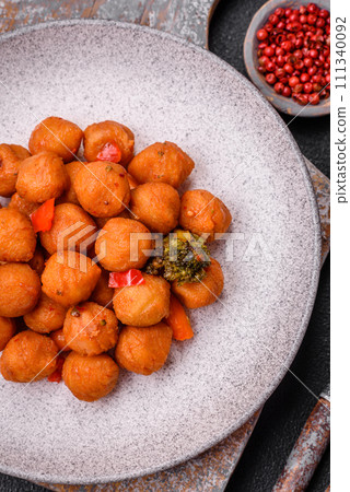 Delicious fried potato balls with vegetables, salt, spices and herbs 111340092