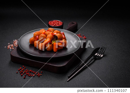 Delicious fried potato balls with vegetables, salt, spices and herbs 111340107