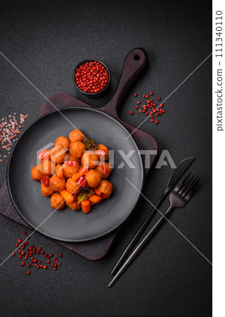 Delicious fried potato balls with vegetables, salt, spices and herbs Delicious fried potato balls with vegetables, salt, spices and herbs 111340110