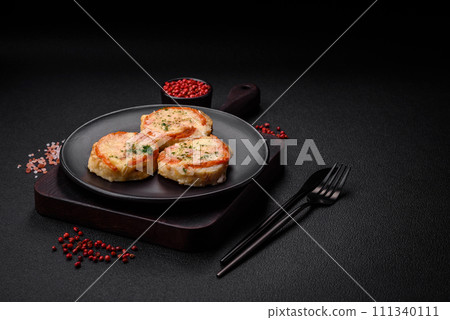 Delicious baked fish fillet with cheese, tomatoes, salt, spices and herbs 111340111