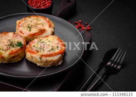 Delicious baked fish fillet with cheese, tomatoes, salt, spices and herbs Delicious baked fish fillet with cheese, tomatoes, salt, spices and herbs 111340115
