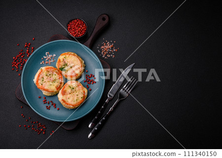 Delicious baked fish fillet with cheese, tomatoes, salt, spices and herbs Delicious baked fish fillet with cheese, tomatoes, salt, spices and herbs 111340150