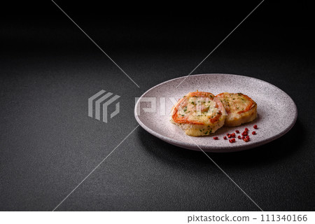 Delicious baked fish fillet with cheese, tomatoes, salt, spices and herbs Delicious baked fish fillet with cheese, tomatoes, salt, spices and herbs 111340166
