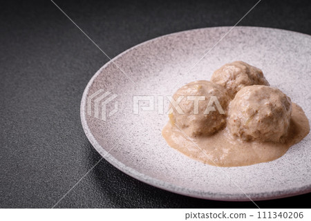 Delicious meatballs from minced chicken or turkey with sour cream sauce Delicious meatballs from minced chicken or turkey with sour cream sauce 111340206