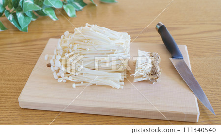 Cut the stems of enoki mushrooms 111340540
