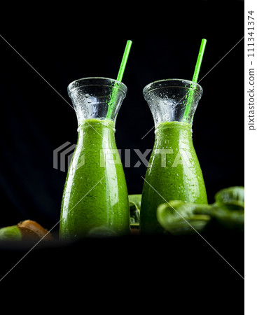 Healthy green smoothies with spinach, apple, kiwi, broccoli and mint in glass jar with fruits and vegetables on the wooden table. Detox and healthy concept 111341374