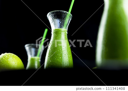 Healthy green smoothies with spinach, apple, kiwi, broccoli and mint in glass jar with fruits and vegetables on the wooden table. Detox and healthy concept Healthy green smoothies with spinach, apple, kiwi, broccoli and mint in glass jar with fruits and vegetables on the wooden table. Detox and healthy concept 111341408