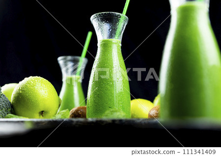 Healthy green smoothies with spinach, apple, kiwi, broccoli and mint in glass jar with fruits and vegetables on the wooden table. Detox and healthy concept 111341409