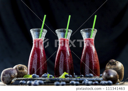 Smoothies with Beetroot, blueberries and mint in glass jar with fruits and vegetables on the wooden table. Detox, diet, healthy, vegetarian drink concept 111341463