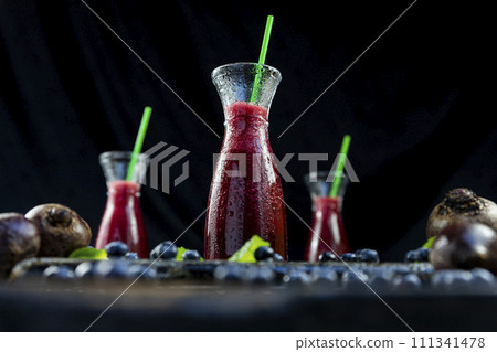 Juice with Beetroot, blueberries and mint in glass jar with fruits and vegetables on the wooden table. Detox, diet, healthy, vegetarian drink concept 111341478