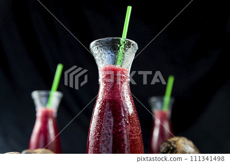 Juice with Beetroot, blueberries and mint in glass jar with fruits and vegetables on the wooden table. Detox, diet, healthy, vegetarian drink concept 111341498
