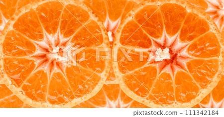 Tangerine slices close-up photo. Orange food background of ripe clementines. Tangerine slices close-up photo. Orange food background of ripe clementines. 111342184