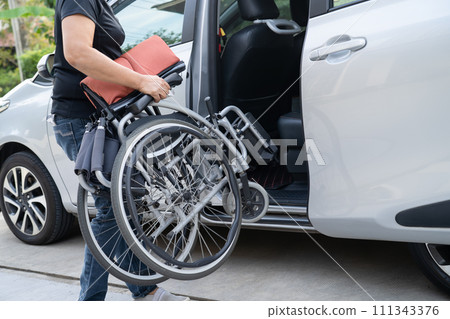 Asian disability woman on wheelchair getting in her car, Accessibility concept. Asian disability woman on wheelchair getting in her car, Accessibility concept. 111343376