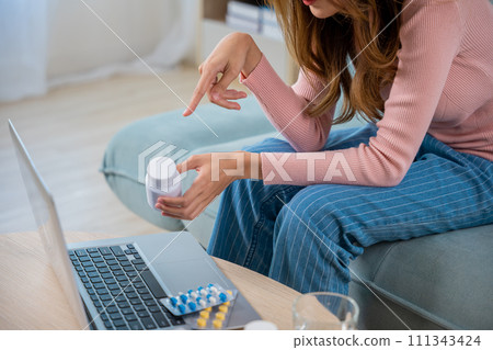 Telehealth. Asian young woman sick using laptop for video conference to doctor consultation asking about illness and medication, Telemedicine healthcare and online to hospital Telehealth. Asian young woman sick using laptop for video conference to doctor consultation asking about illness and medication, Telemedicine healthcare and online to hospital 111343424