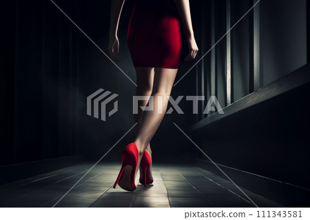 A woman's legs in red heels walking through a dimly lit corridor, creating an aura of intrigue 111343581