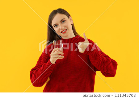 Attractive naked girl drinks water from a glass Attractive naked girl drinks water from a glass 111343708