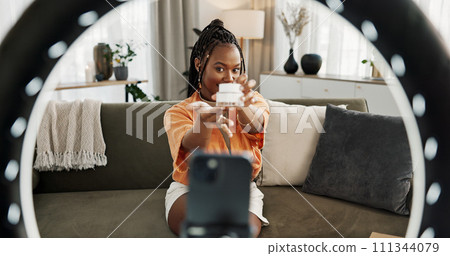 Video, influencer and black woman doing skincare for tutorial on social media or the internet. Dermatology, happy and young African female person filming or live streaming facial routine at home. 111344079