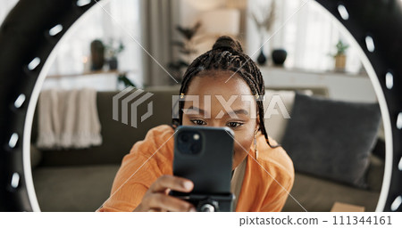 Video, content creator and black woman doing skincare for tutorial on social media or the internet. Dermatology, happy and African female influencer filming or live streaming face routine at home. Video, content creator and black woman doing skincare for tutorial on social media or the internet. Dermatology, happy and African female influencer filming or live streaming face routine at home. 111344161