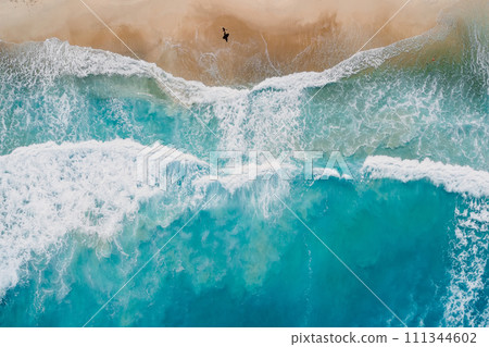 Surfer walk on beach with blue ocean and waves. Aerial view 111344602