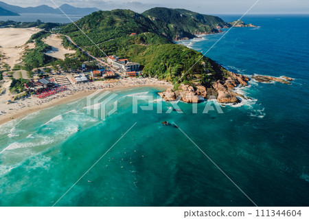 Popular holiday beach with cape and ocean with waves in Brazil. Aerial view 111344604